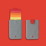 Emplacements de cartes allant du jaune au rouge avec un cuir gris pour ce porte-cartes.